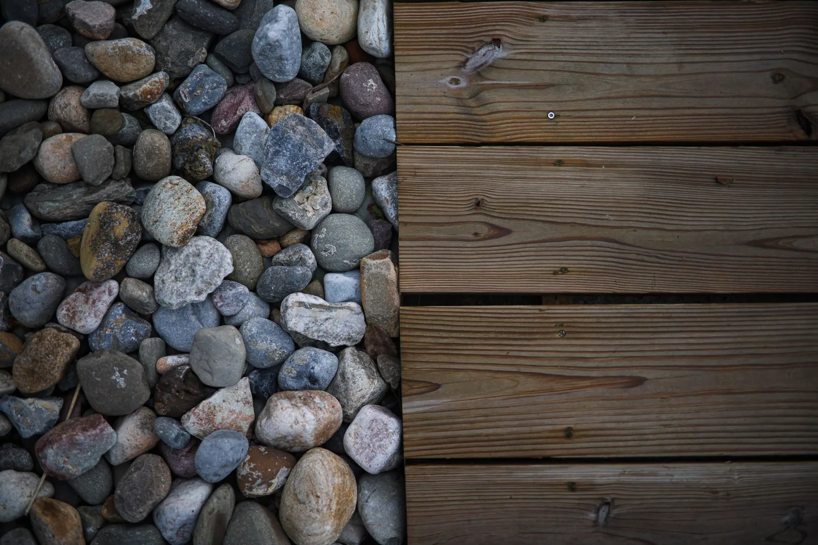 how to build a deck on the ground — woman building a ground-level deck with pressure-treated lumber