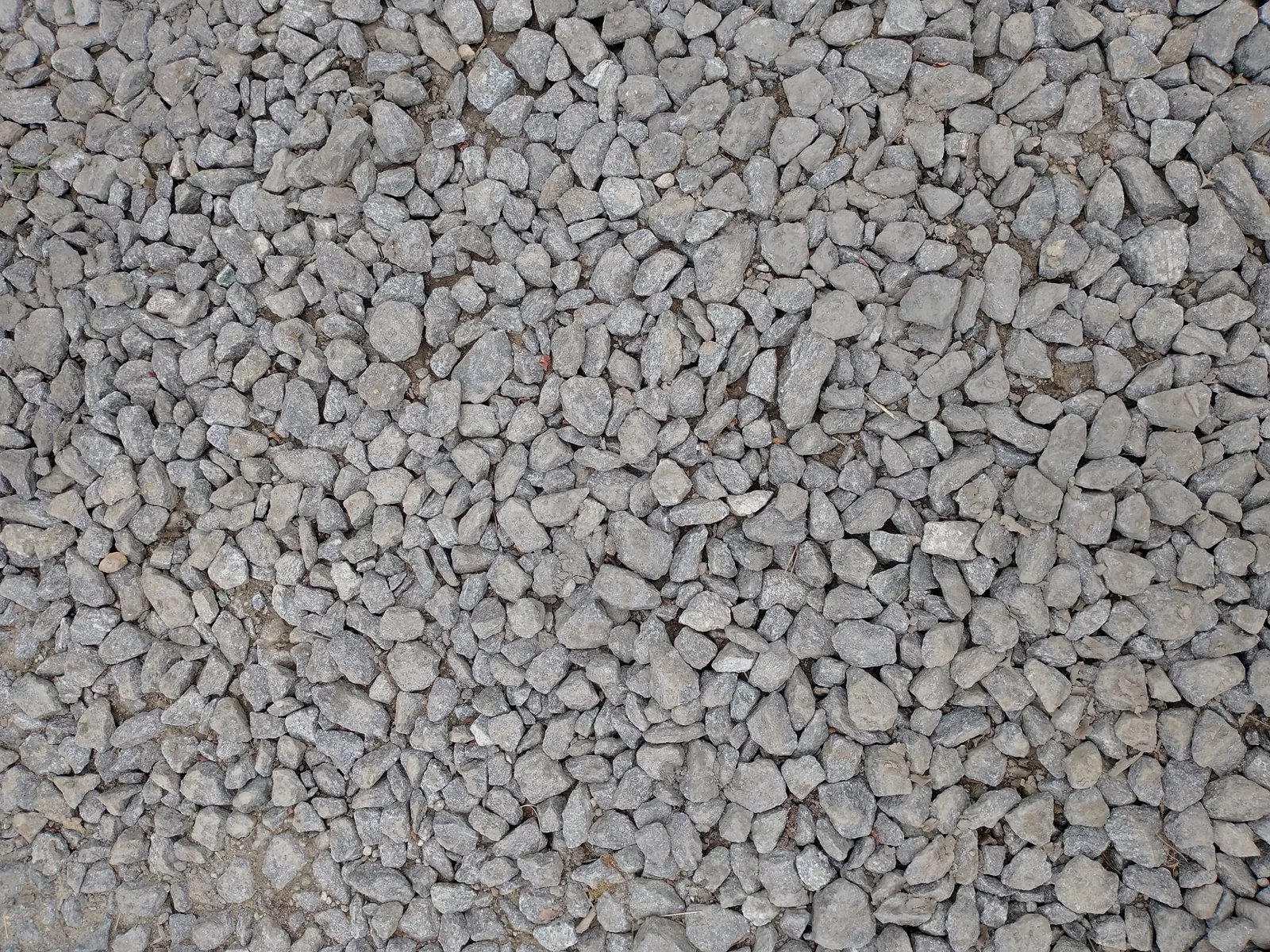 Pebble stone driveway ideas with rounded river rock and steel edging
