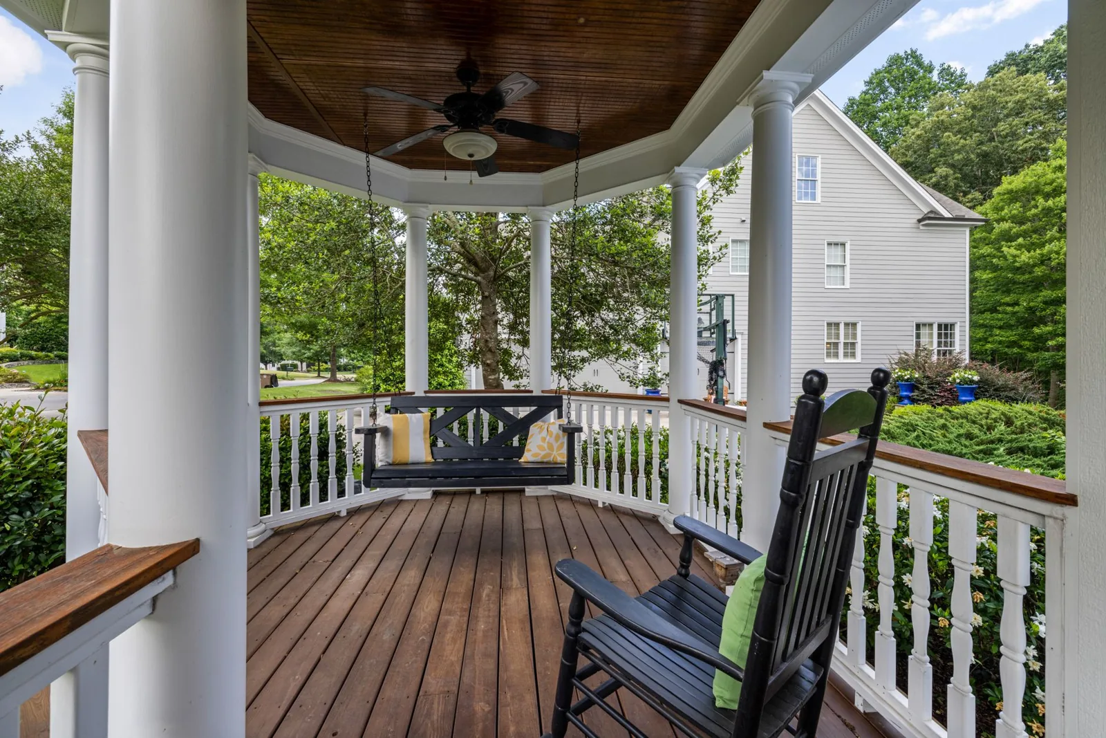 A shaded deck with a pergola and outdoor lounge furniture