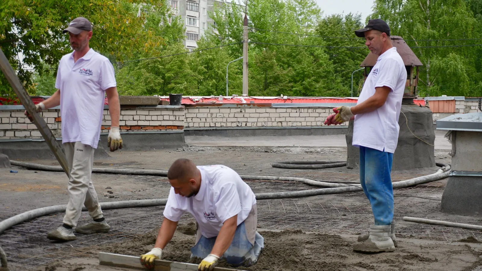 Freshly poured self-leveling compound smoothing an uneven concrete patio