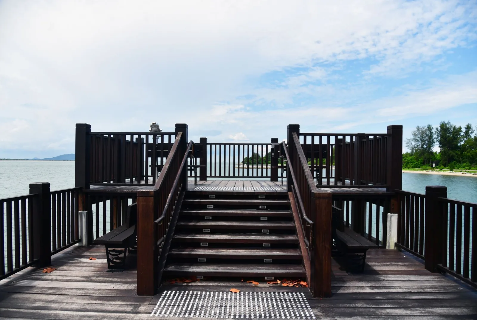 A set of floating composite deck stairs over gravel